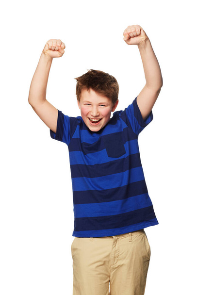 Portrait, celebration and excited kid with hands raised in studio isolated on a white background. Boy, winner and happy child celebrate achievement, success or winning, happiness and victory - Fotografie, Obrázek