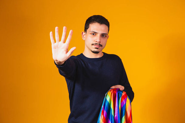 Gay pride. Homosexual boy with his hand forward making a stop sign to prejudice - Valokuva, kuva