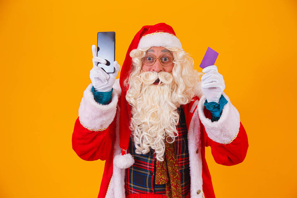 Santa Claus using credit card to pay for internet purchases - Foto, Imagem