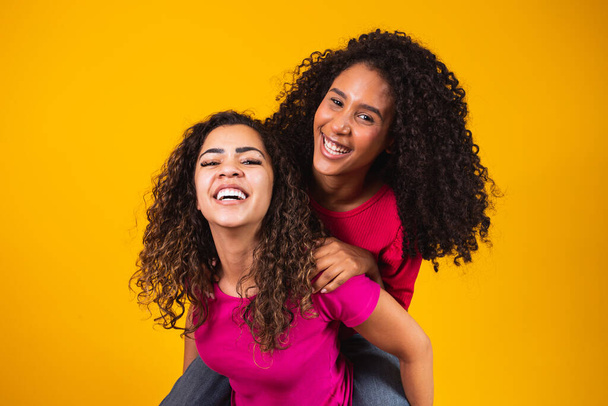 Two beautiful afro friends hugged, concept of best friends and sisters. - Fotoğraf, Görsel
