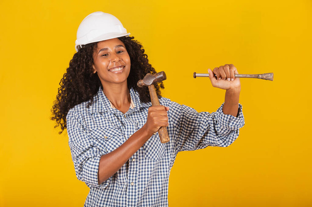 female contractor holding a hammer - Фото, изображение