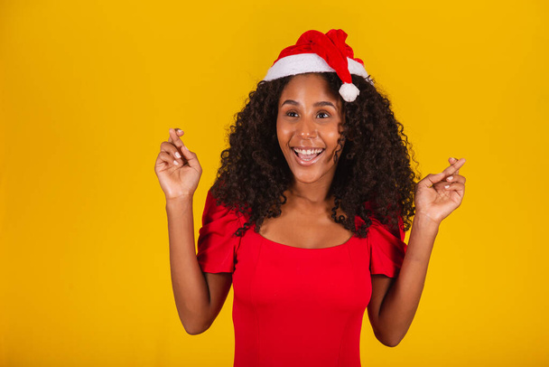 Expressive Excited Woman with Santa Hat on Yellow Background. - Foto, afbeelding