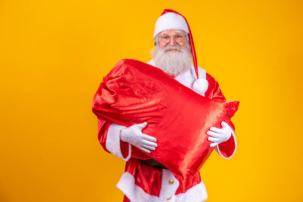Santa Claus holding a bag full of presents - Photo, Image