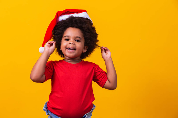 Little afro girl child with Santa Claus hat. - Photo, image