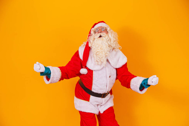 Santa Claus celebrating victory in yellow background - Zdjęcie, obraz