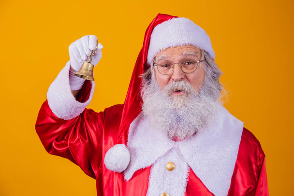 Santa Claus ringing a small bell. Jingle Bells. Savings on purchases. Christmas is coming. Preparing for the Christmas night. Sales promotion. - Fotoğraf, Görsel