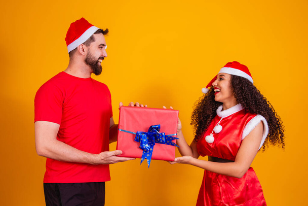 Young couple of lovers exchanging gifts on Christmas. Merry Christmas - Foto, afbeelding