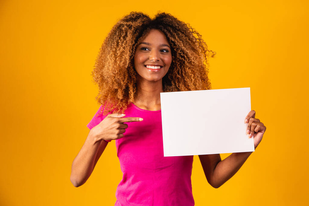 Woman shows empty board. Advertising board. Black friday. Advertising. Smiling woman holds empty advertising banner. Ready for your text. Sale and discount. Season sales. - Φωτογραφία, εικόνα