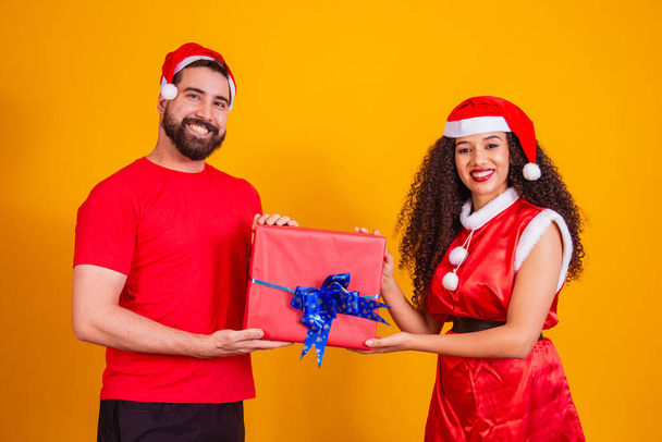 Young couple of lovers exchanging gifts on Christmas. Merry Christmas - Foto, Bild