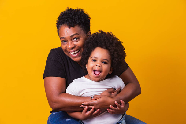 happy mother's day! Adorable sweet afro-american mother with cute little daugh. Older mother with her daughter on yellow background. - Foto, afbeelding