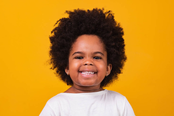 Closeup of happy little black girl smiling with space for text. - Фото, зображення