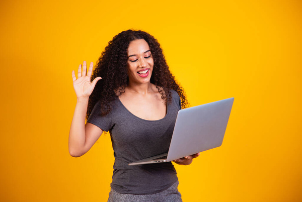 Remote! Portrait of excited young afro woman holding laptop computer on a video call. - Φωτογραφία, εικόνα