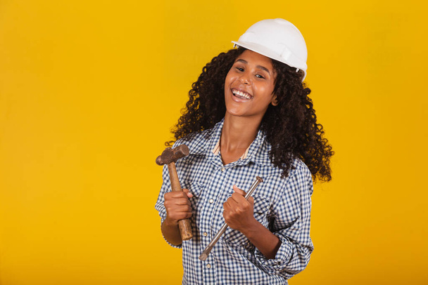 female contractor holding a hammer - Фото, изображение