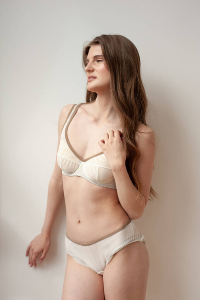 beautiful young woman in beige underwear  - Фото, зображення