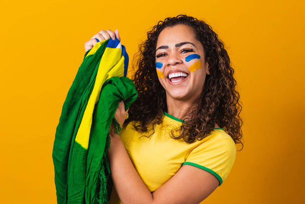 brazilian fan with her face painted in blue and yellow for the b - Foto, imagen