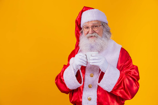 Real Santa holding a cup of coffee - Foto, afbeelding
