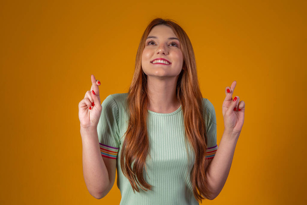 Young woman with crossed fingers. Luck - Фото, изображение