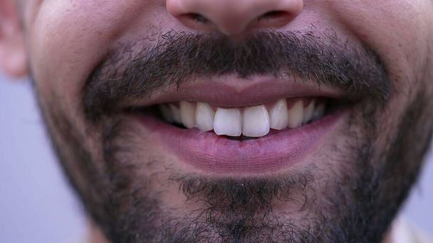 One happy MIddle Eastern man closeup mouth smile in macro. Bearded male person smiling at camera close up detail of teeth - Fotó, kép