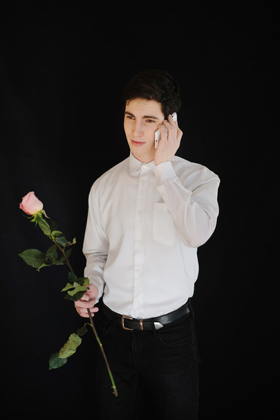 young man with a rose talking on telephone - Fotoğraf, Görsel