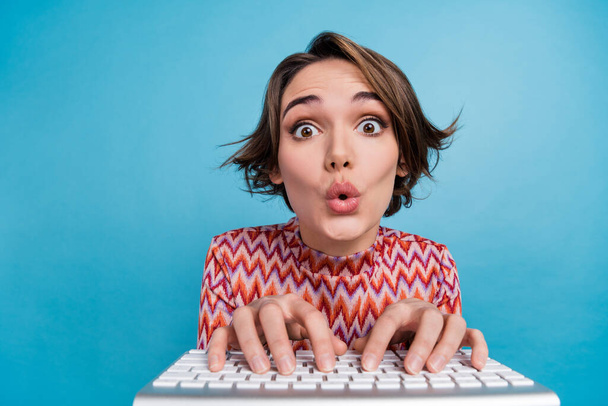Photo of funky impressed lady wear striped top chatting keyboard big eyes isolated blue color background. - Фото, зображення