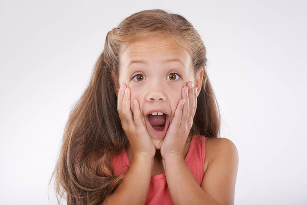 Shes so shocked. Cropped image of a little girl looking surprised - Фото, изображение