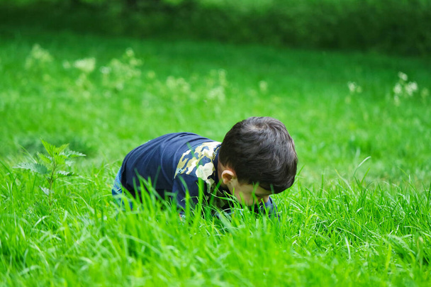 Luton, England, United Kingdom - May 9, 2023: cute little boy in spring park  - Fotó, kép