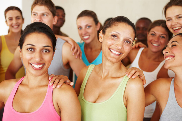 Keeping in shape makes them happy. Portrait of a a group of yoga enthusiasts standing in a yoga studio - Photo, Image