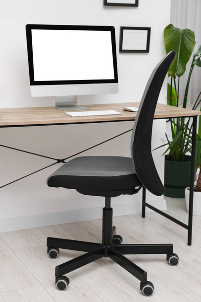 Comfortable office chair near desk in modern workplace - Foto, Imagen