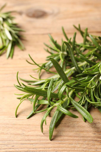 Fresh green rosemary on wooden table, closeup - Photo, image