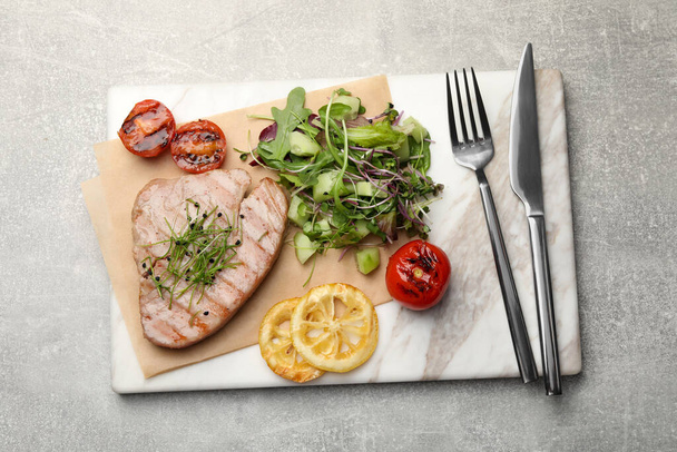 Delicious tuna steak served on light grey table, top view - Fotó, kép