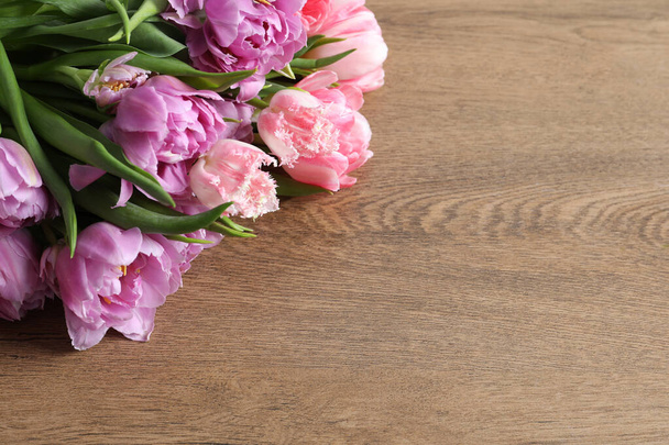 Beautiful bouquet of colorful tulip flowers on wooden table, space for text - Fotoğraf, Görsel