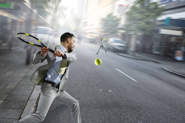 Businessman playing tennis. Mixed media - Φωτογραφία, εικόνα