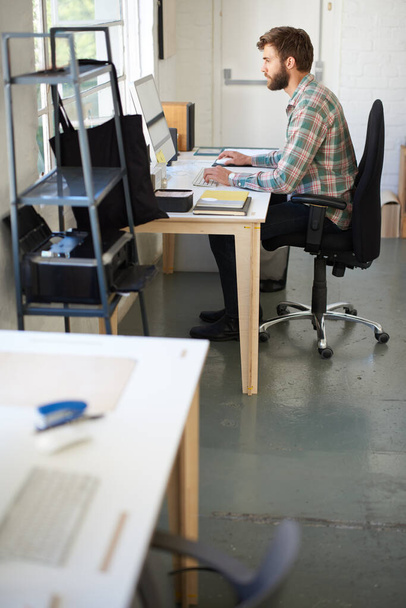 Hes designing your dreams. High angle shot of a designer working a this desk - Valokuva, kuva