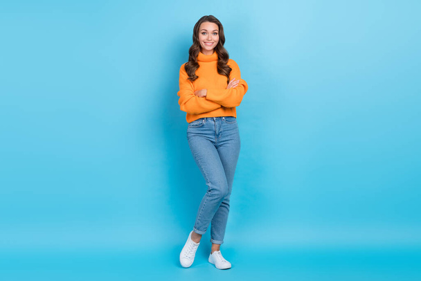Full length photo of positive confident lady dressed orange pullover arms crossed isolated blue color background. - Foto, Imagen