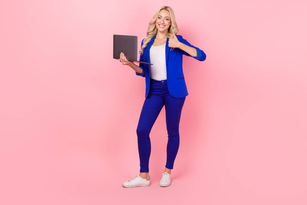 Photo of business lady browse small netbook raise thumb finger up wear smart casual outfit isolated pink color background. - Foto, Bild