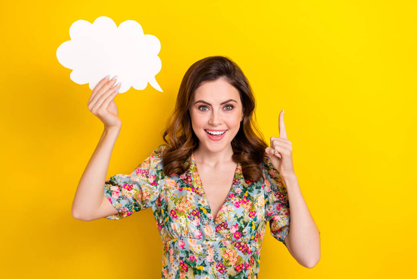 Portrait of excited pretty lady hand hold empty space cloud figure card point finger isolated on yellow color background. - Foto, Bild