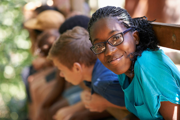 Black girl, camp or friends portrait with happiness or glasses outdoor. Happy, African and female teen with face and a smile from summer camping, holiday or team building with fun people in treehouse. - Foto, Imagen