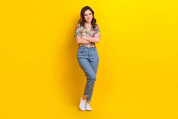 Full length photo of sweet dreamy lady wear retro flower print blouse arms crossed isolated yellow color background. - Foto, afbeelding
