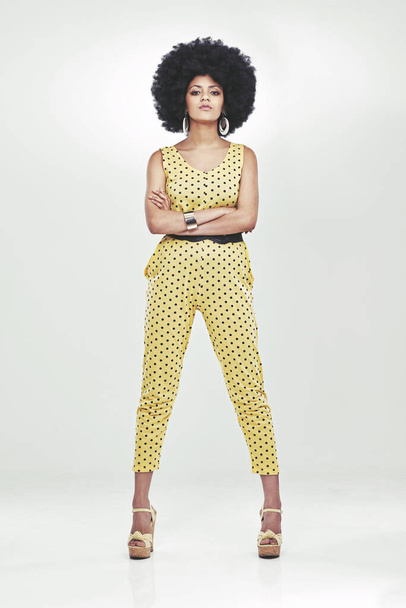 Shes one funky chick. Full length portrait of young woman wearing a 70s retro jumpsuit striking a pose in studio - Foto, Imagem