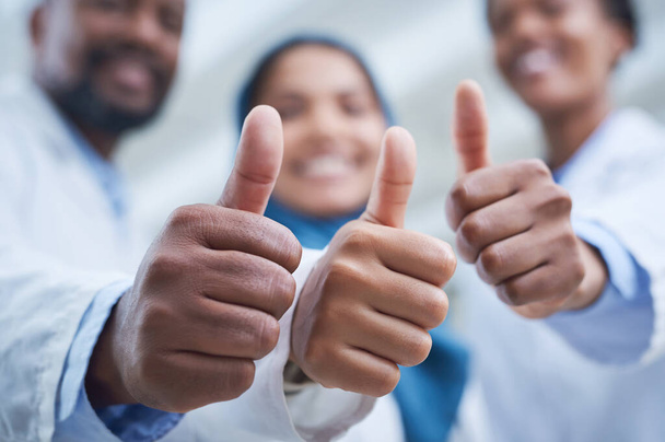 You asked, we solved. a group of scientists showing thumbs up while conducting research in a laboratory - Фото, зображення