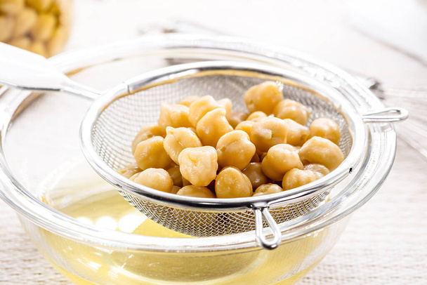Aquafaba is the liquid for cooking chickpeas. Vegan or vegetarian ingredient used as a homemade alternative to egg whites in many recipes - Photo, Image