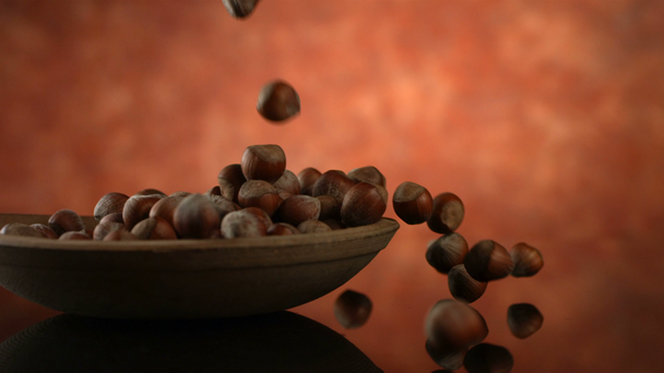 Hazelnuts falling into bowl - Felvétel, videó