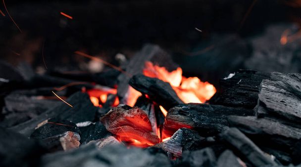 Close-up of orange glowing embers of charcoal. Barbecue grill in the garden. Leisure activity, outdoors. - Fotó, kép