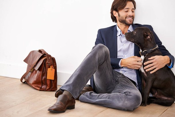 Hes my best friend. A handsome businessman sitting next to his loyal dog - Zdjęcie, obraz