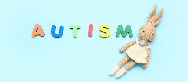 Word AUTISM and toy on light blue background - Фото, зображення
