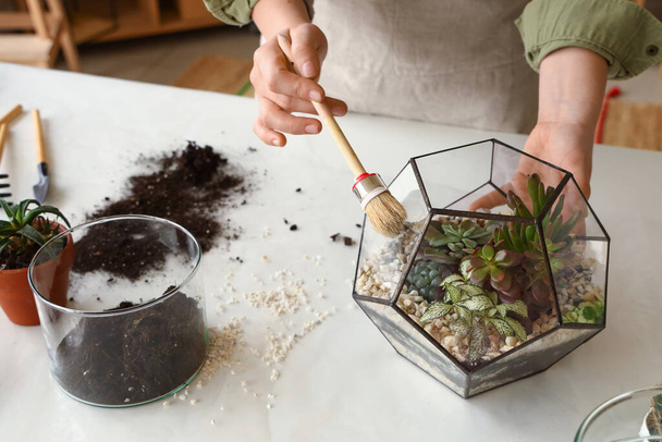 Woman making florarium on table at home, closeup - Photo, Image
