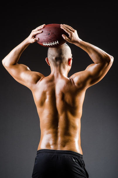 Muscular football player with ball - Foto, imagen