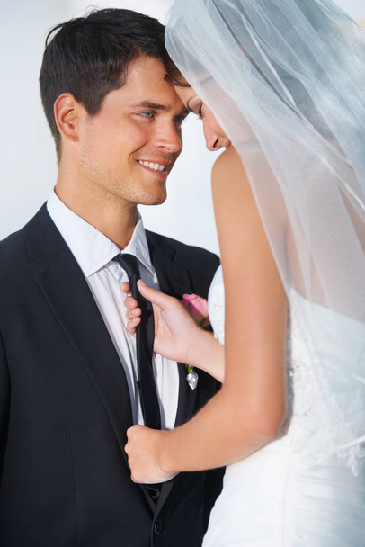 From this day forward...A young bride pulling affectionately on her husbands tie - Foto, imagen