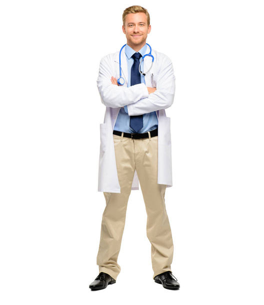 Handsome young doctor posing with his arms folded in studio. Fullbody confident friendly caucasian general practitioner standing with arms crossed. - Foto, afbeelding
