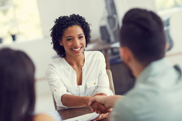 Handshake, meeting and a happy therapist with couple for a consultation, counseling and therapy. Smile, greeting and African psychologist shaking hands with a man and woman for marriage counselling. - Foto, Imagen